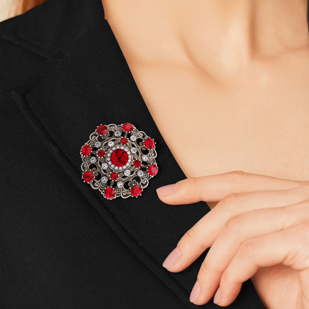 NEWBRIDGE BROOCH WITH RUBY COLOURED STONES