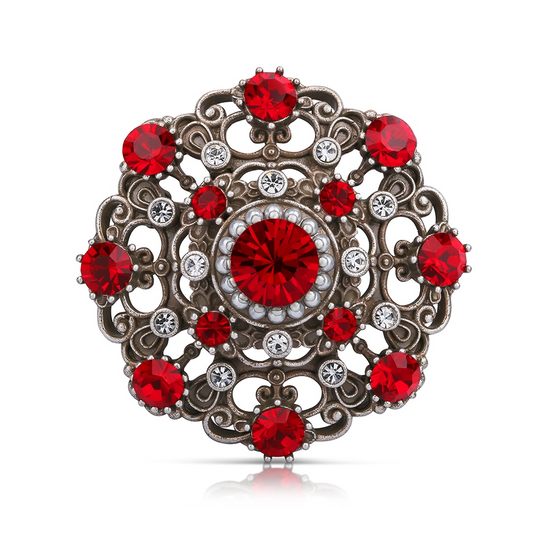 NEWBRIDGE BROOCH WITH RUBY COLOURED STONES